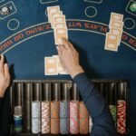 blackjack table with cards and chips - blackjack hand signals guide