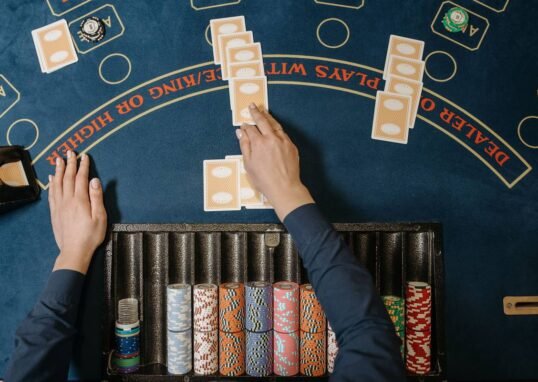 blackjack table with cards and chips - blackjack hand signals guide