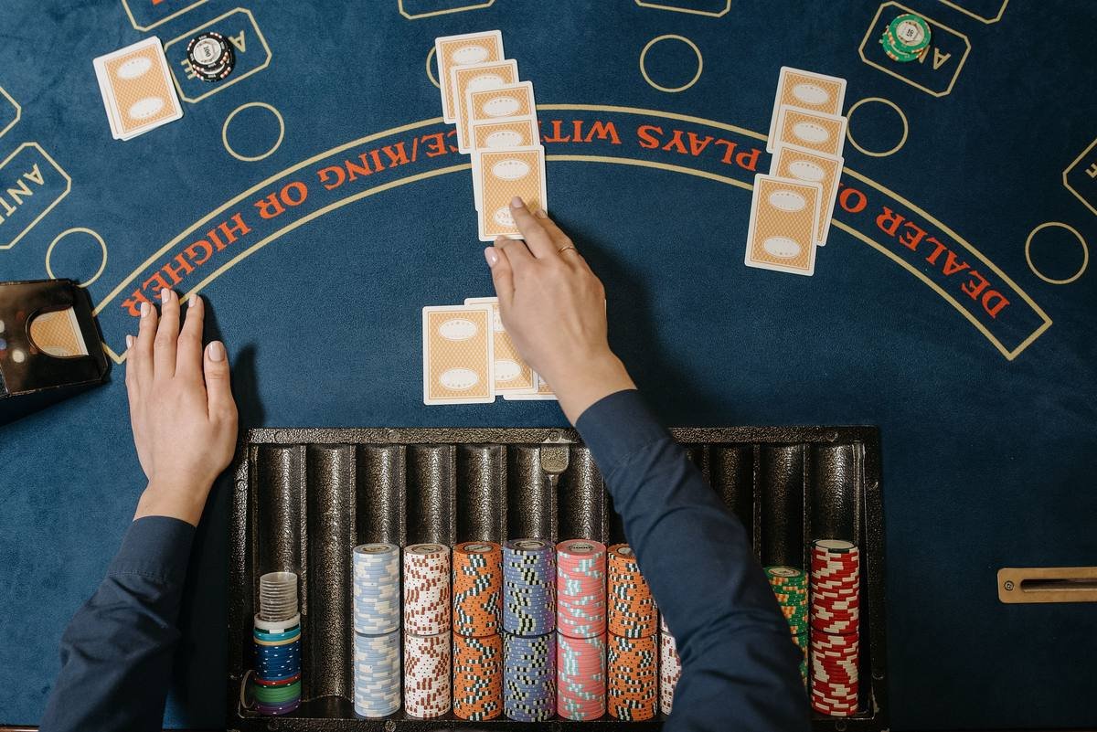 blackjack table with cards and chips - blackjack hand signals guide